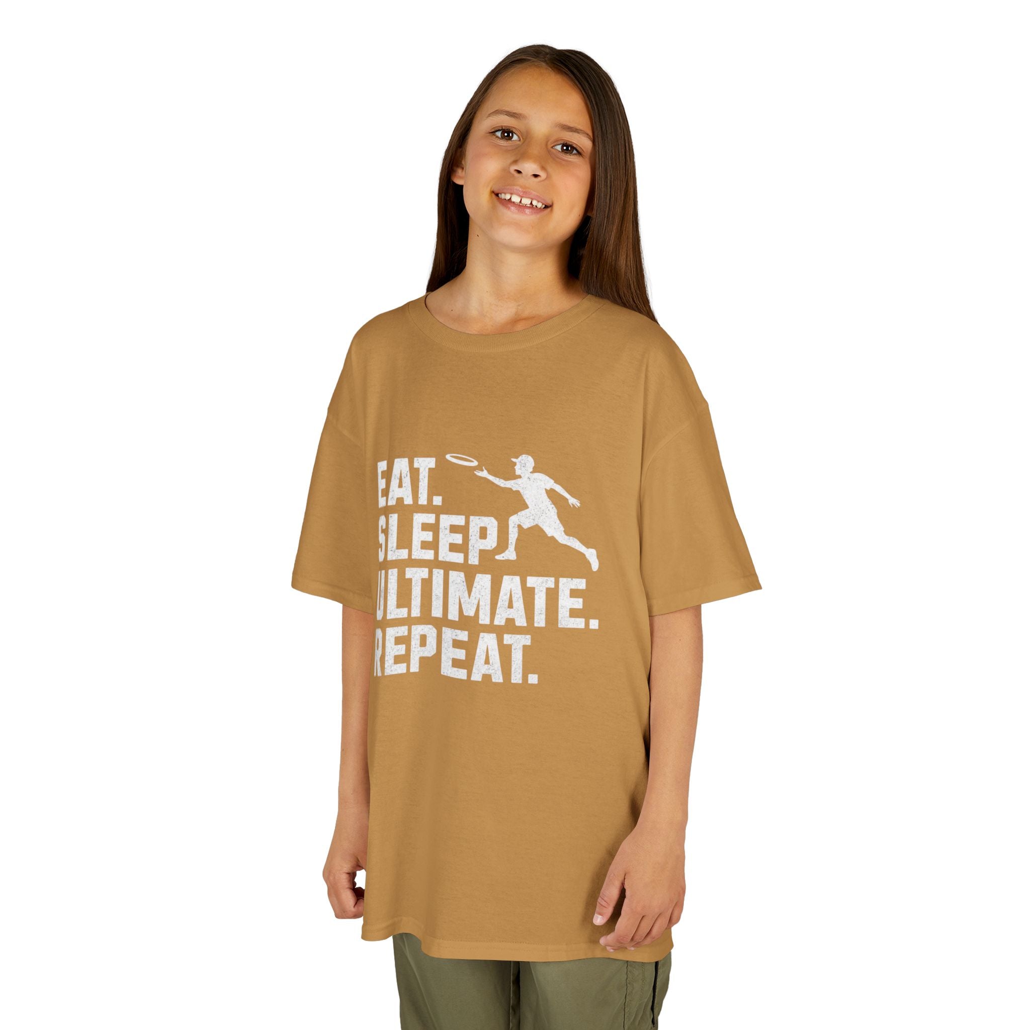 Child wearing a tan t-shirt with 'Eat. Sleep. Ultimate. Repeat.' text and graphic on a white background