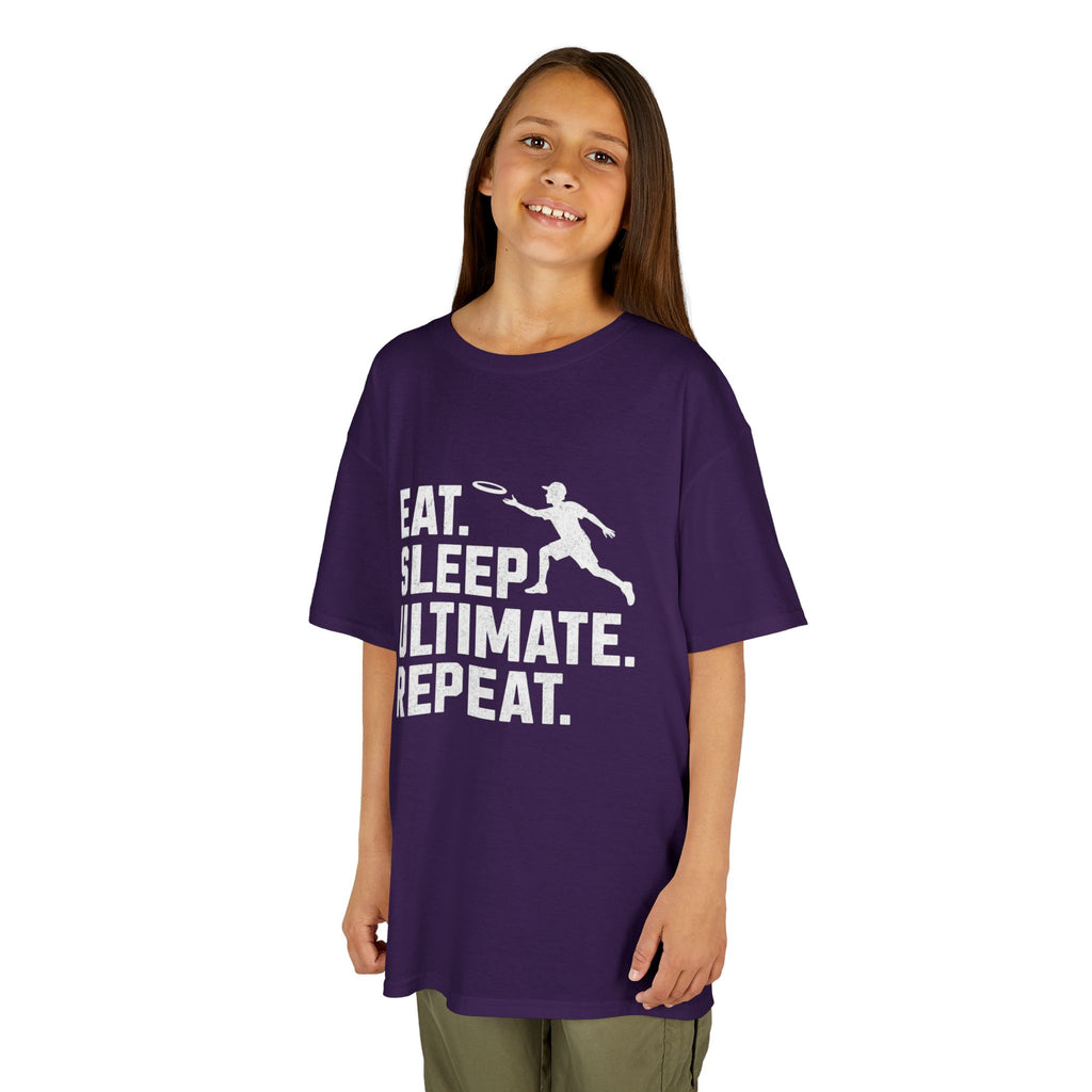 Child wearing a purple t-shirt with 'Eat. Sleep. Ultimate. Repeat.' text and graphic on a white background