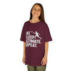 Child wearing a maroon t-shirt with 'Eat. Sleep. Ultimate. Repeat.' text and graphic on a white background