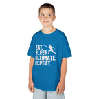 Child wearing a blue t-shirt with 'Eat. Sleep. Ultimate. Repeat.' text and graphic on a white background