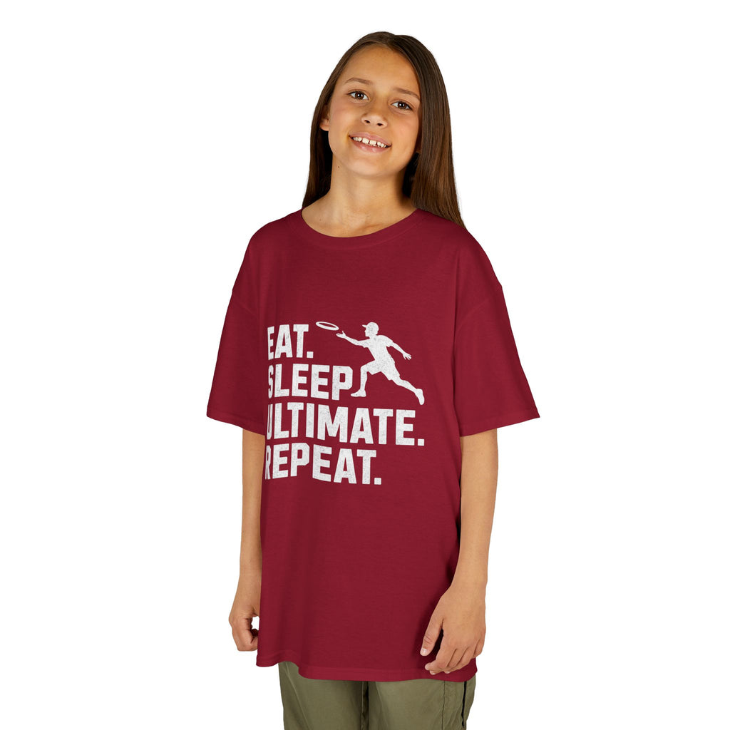 Child wearing a red t-shirt with 'Eat. Sleep. Ultimate. Repeat.' text and graphic on a white background