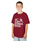 Child wearing a red t-shirt with 'Eat. Sleep. Ultimate. Repeat.' text and graphic on a white background