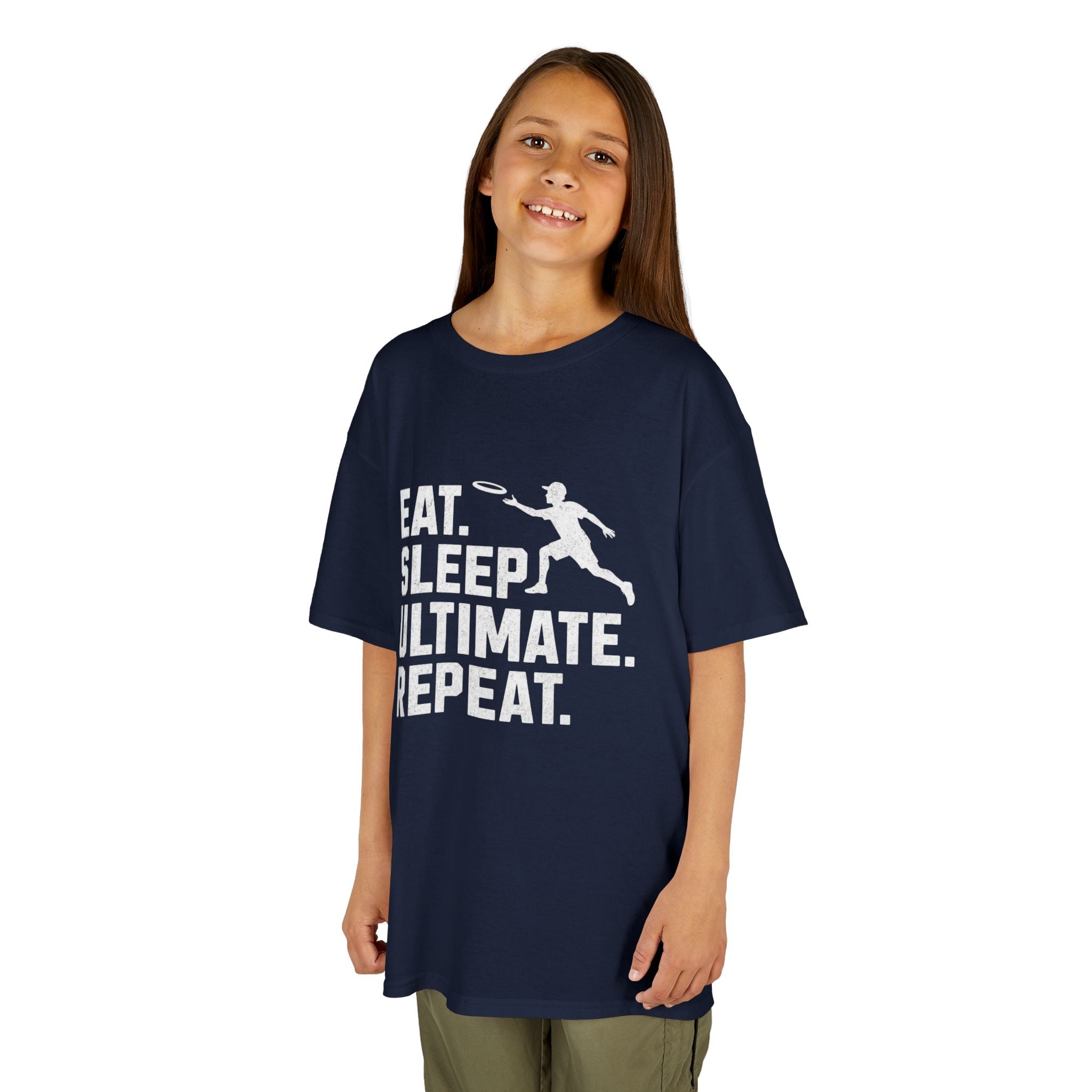 Child wearing a navy blue t-shirt with 'Eat. Sleep. Ultimate. Repeat.' text and graphic on a white background