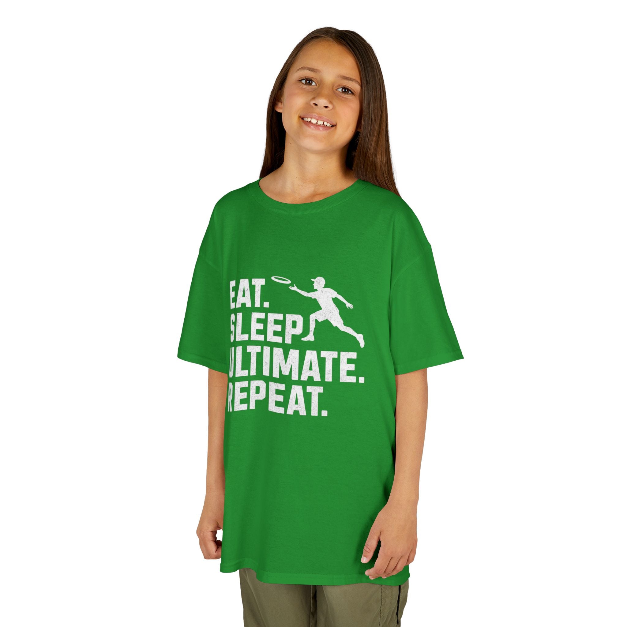 Child wearing a green t-shirt with 'Eat. Sleep. Ultimate. Repeat.' text and graphic on a white background
