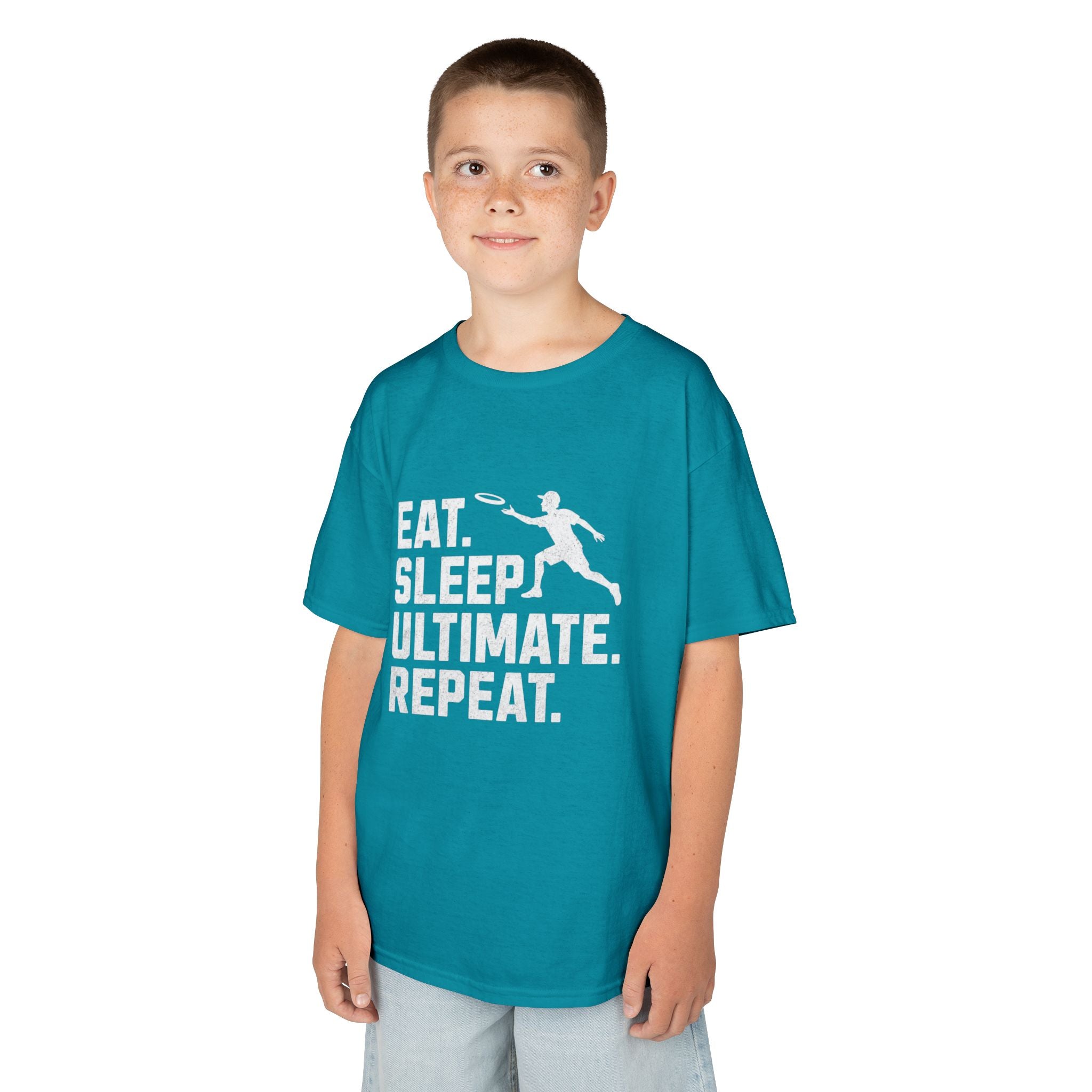 Child wearing a teal t-shirt with 'Eat. Sleep. Ultimate. Repeat.' text and graphic on a white background