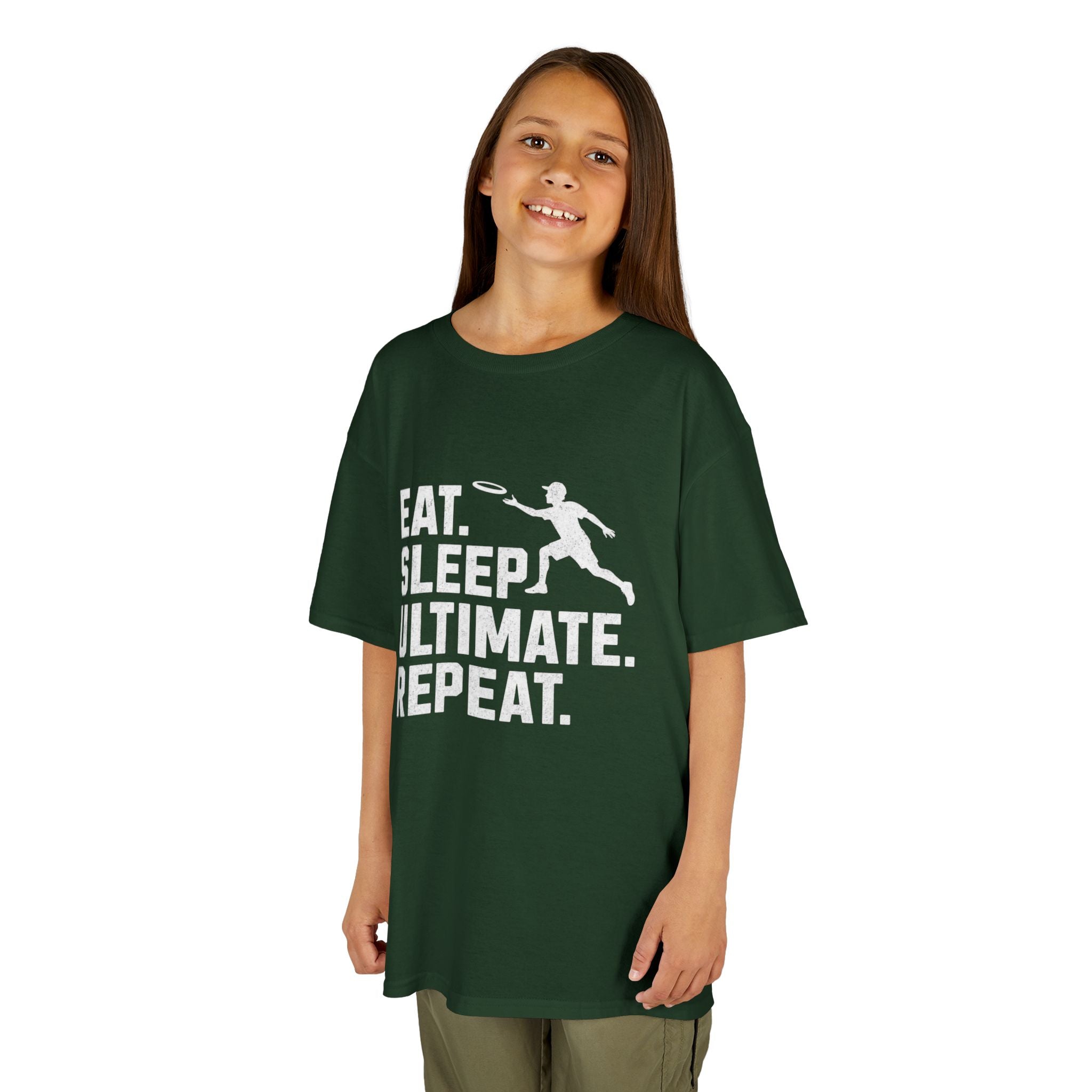 Child wearing a green t-shirt with 'Eat. Sleep. Ultimate. Repeat.' text and graphic on a white background