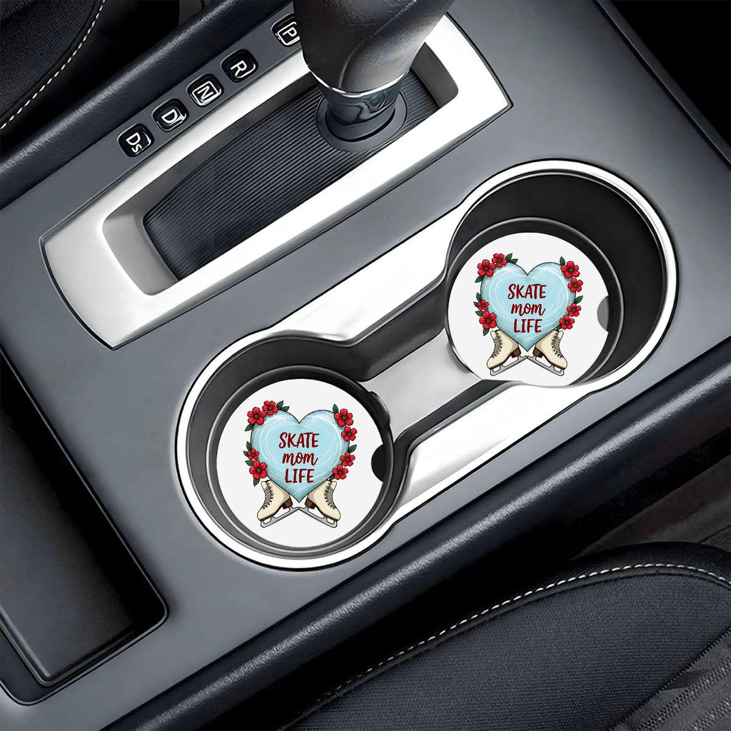 Two car coasters with 'Skate Mom Life' design in a vehicle's cup holder.