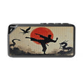 Bluetooth speaker with martial arts design featuring a silhouette of a person kicking, a red sun, and dragons.