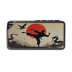 Bluetooth speaker with martial arts design featuring a silhouette of a person kicking, a red sun, and dragons.
