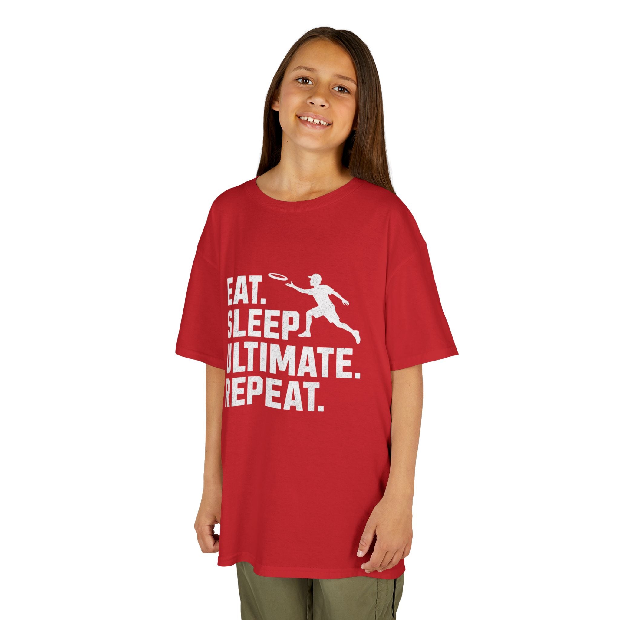 Child wearing a red t-shirt with 'Eat. Sleep. Ultimate. Repeat.' text and graphic on a white background