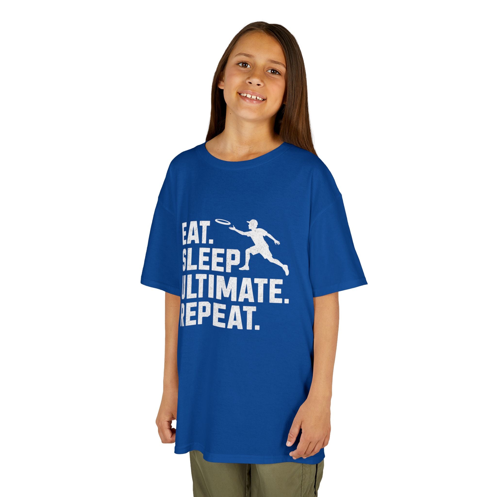 Child wearing a blue t-shirt with 'Eat. Sleep. Ultimate. Repeat.' text and graphic on a white background