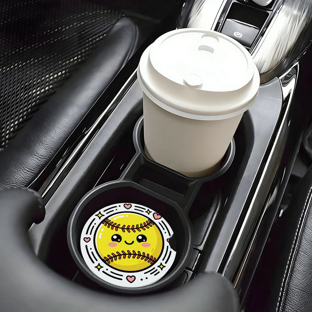 Car cup holder with a white coffee cup and a black coaster with a smiley face design.