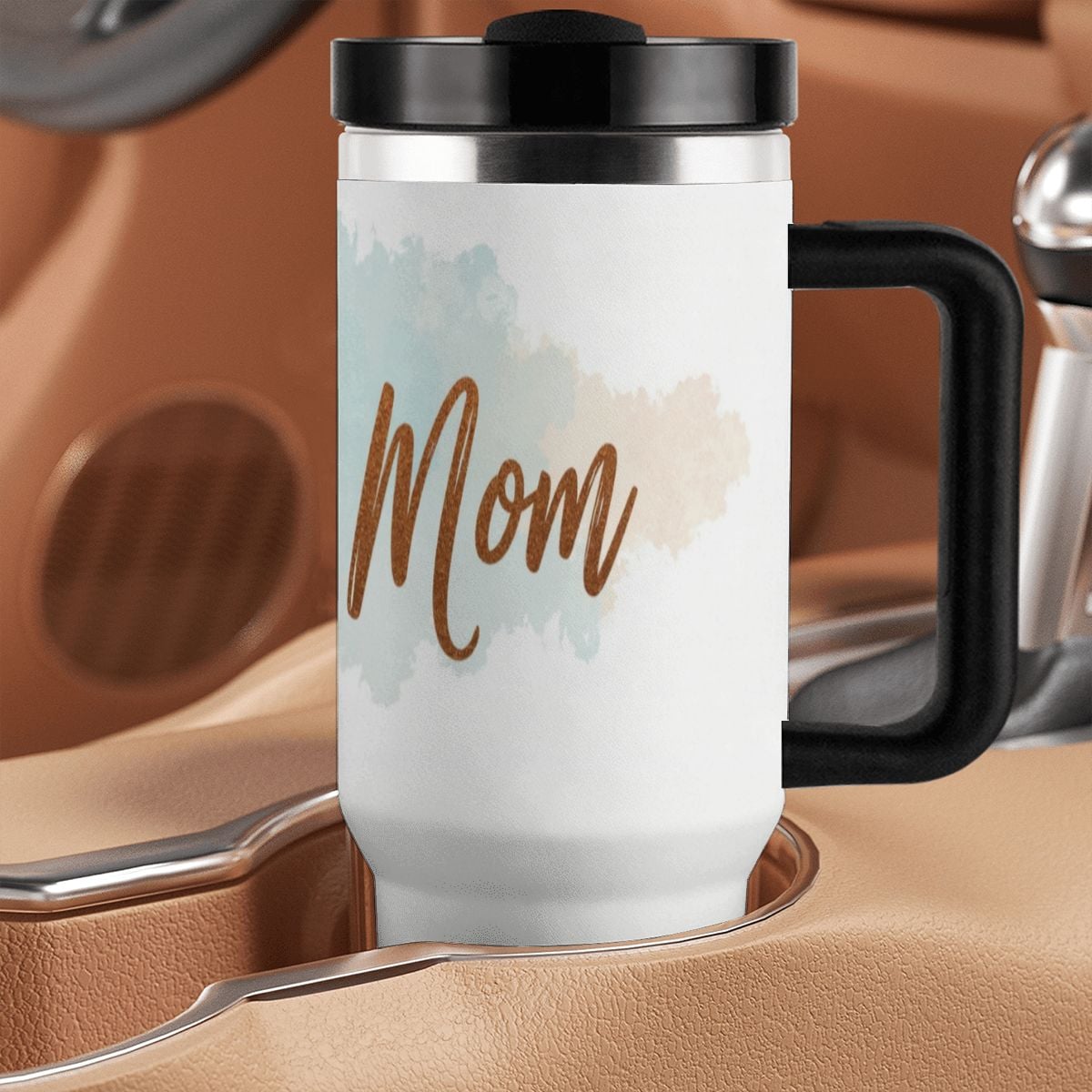 Travel mug with 'Swim Mom' text on a brown leather surface