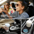 Two women in a car with a focus on absorbent ceramic car coasters.
