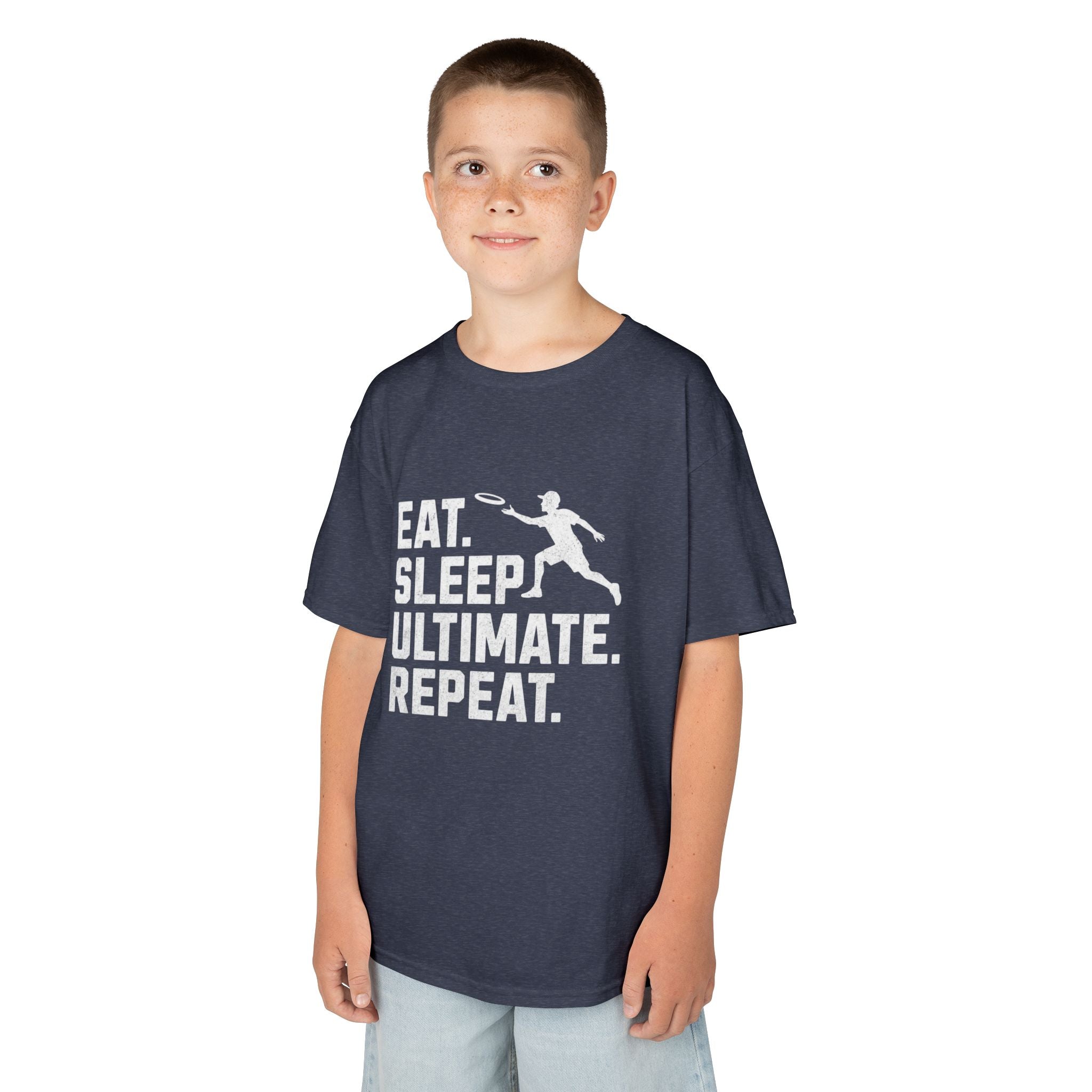 Child wearing a dark gray t-shirt with 'Eat. Sleep. Ultimate. Repeat.' text and graphic on a white background