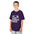 Child wearing a purple t-shirt with 'Eat. Sleep. Ultimate. Repeat.' text and graphic on a white background