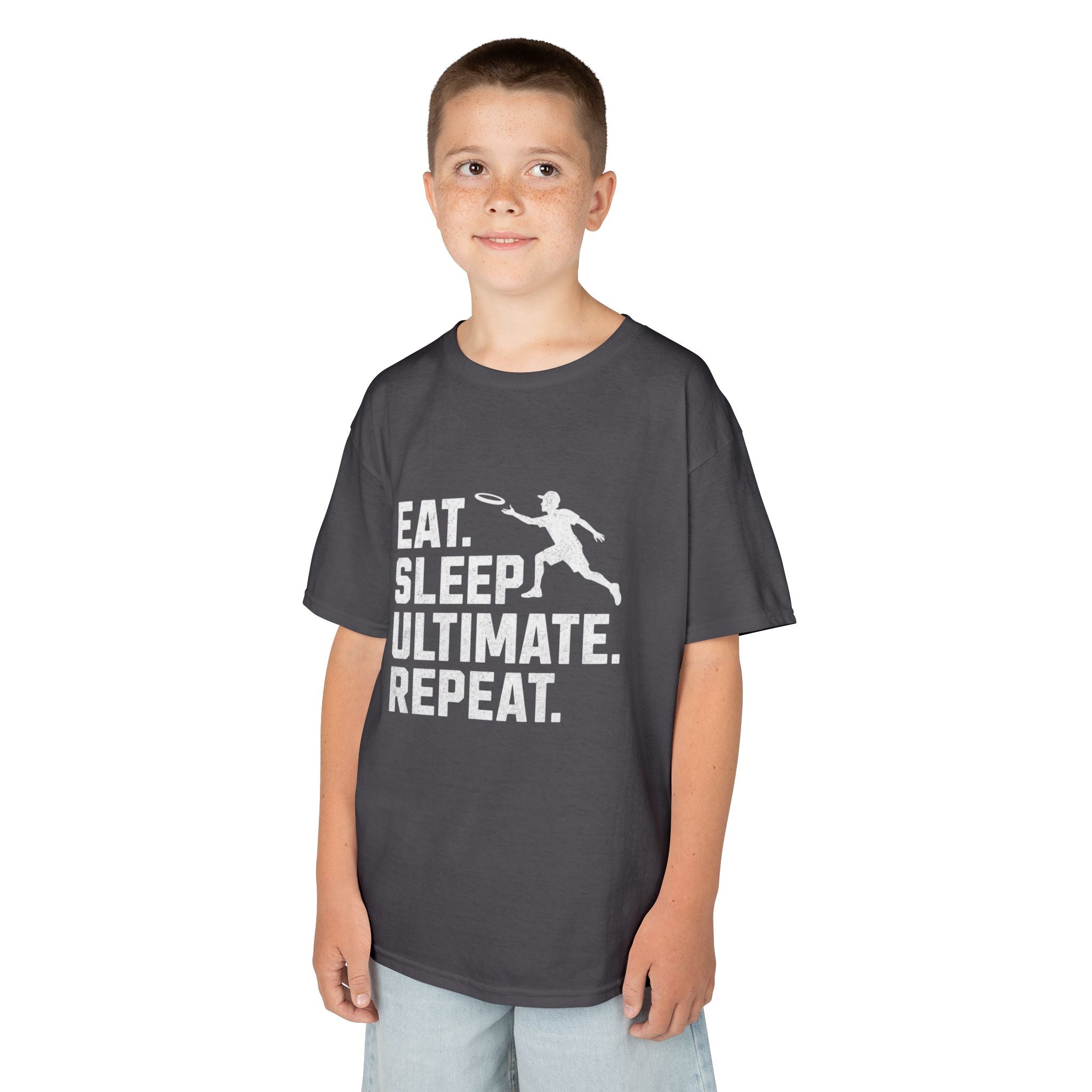 Child wearing a dark gray t-shirt with 'Eat. Sleep. Ultimate. Repeat.' text and graphic on a white background