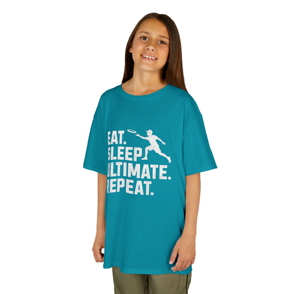 Child wearing a teal t-shirt with white text and graphic on a white background