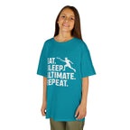 Child wearing a teal t-shirt with white text and graphic on a white background