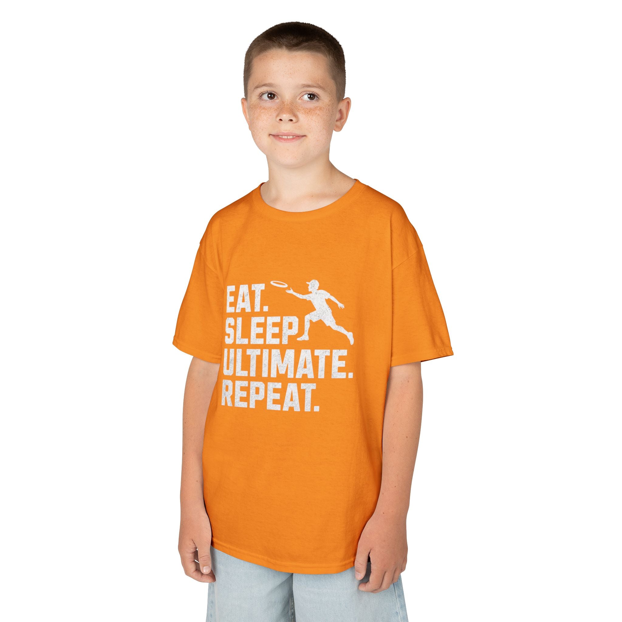 Child wearing an orange t-shirt with 'Eat. Sleep. Ultimate. Repeat.' text and graphic on a white background
