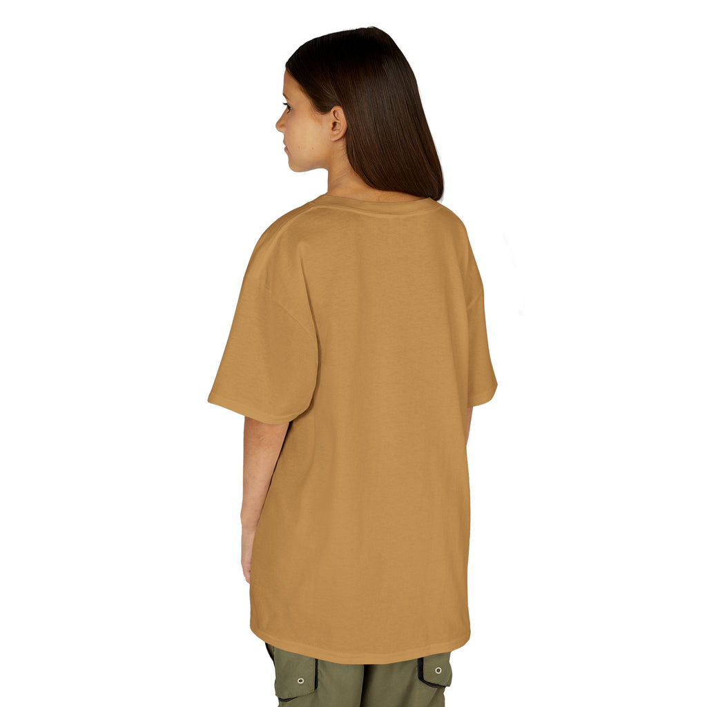 Person wearing a beige oversized t-shirt on a white background
