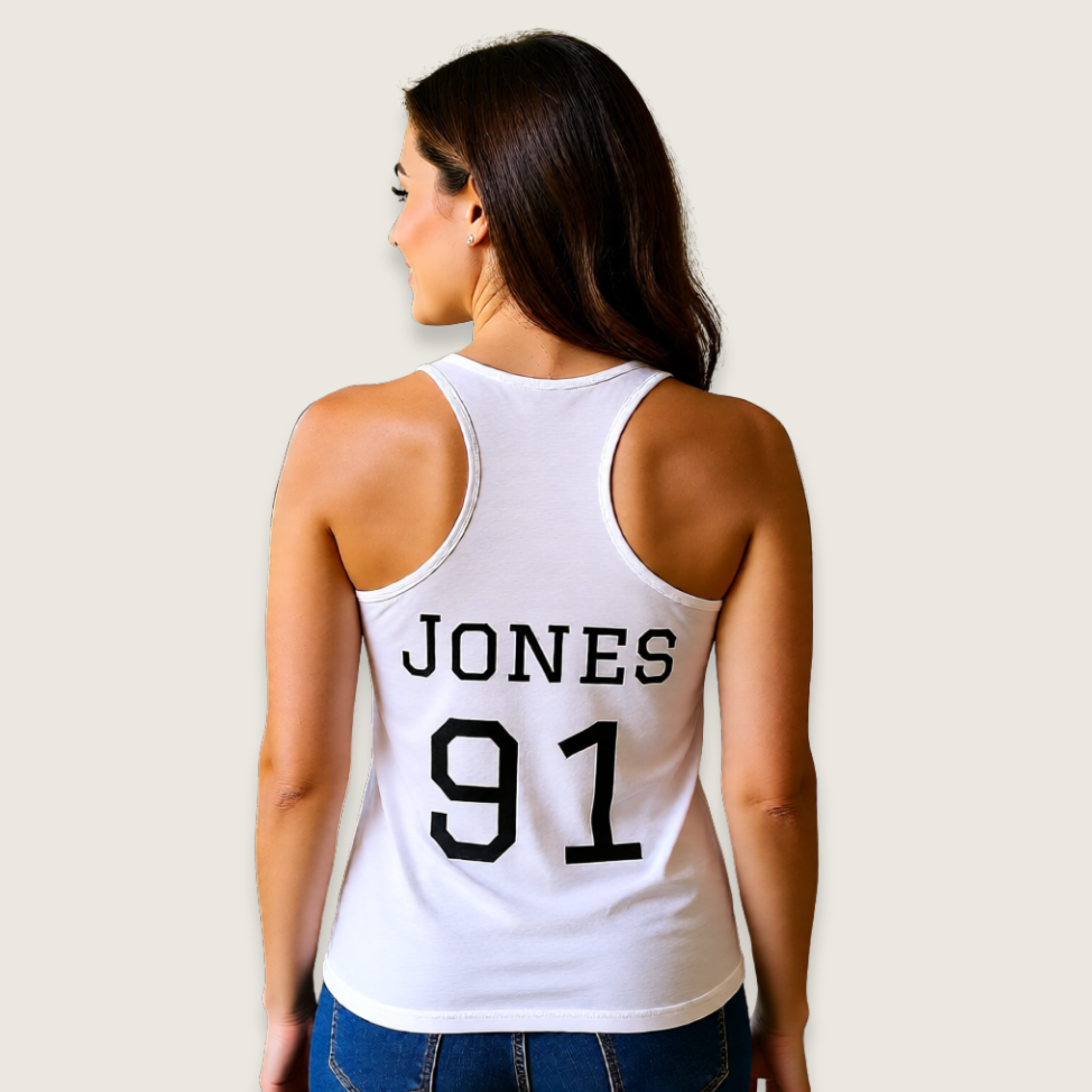 Woman wearing a white tank top with 'JONES 91' printed on the back against a plain background