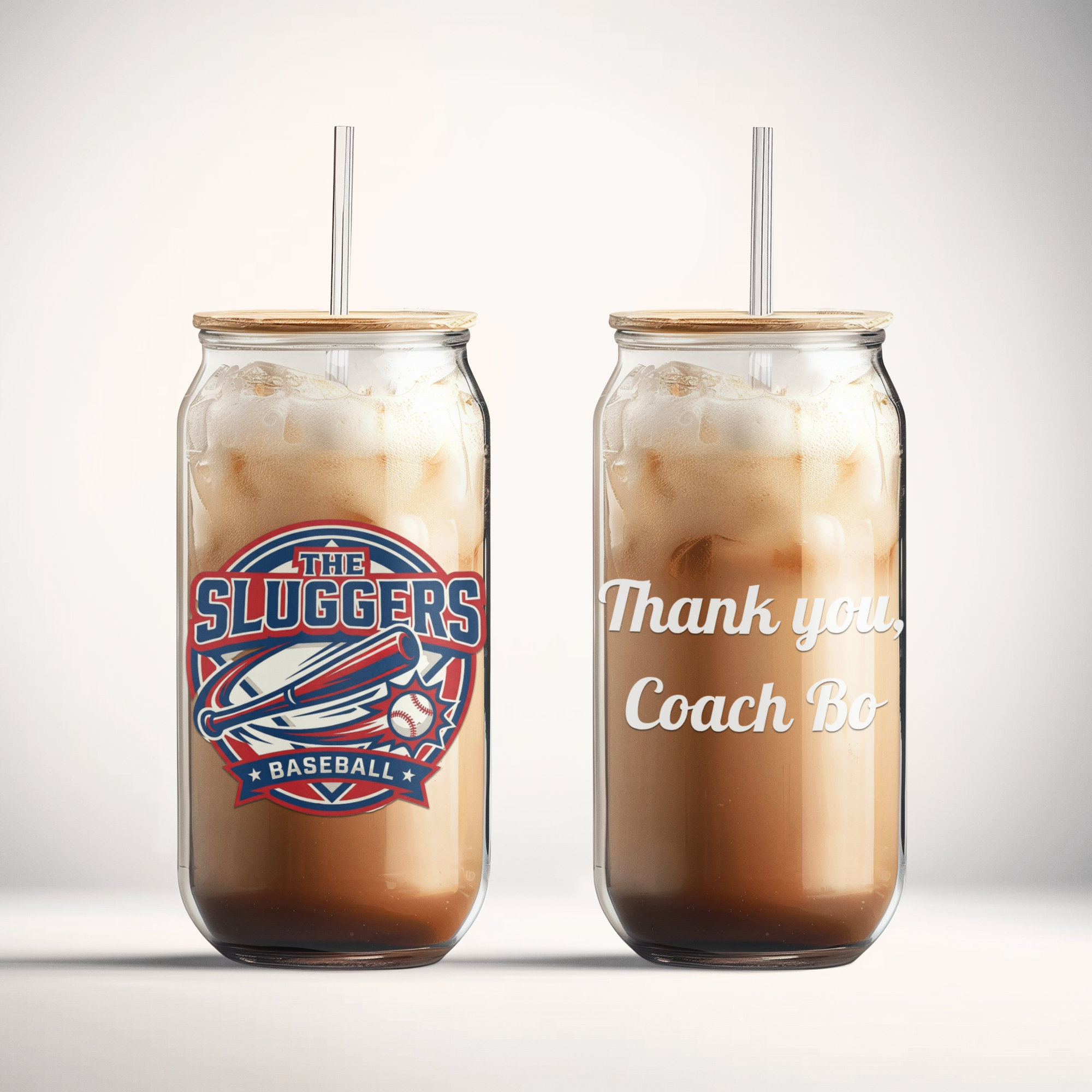 Two iced coffee drinks in mason jars with straws on a gray background