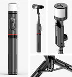 Black and silver camera tripod with multiple angles on a white background