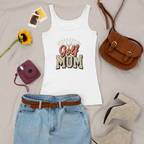 White tank top with 'Golf Mom' text, denim skirt, brown purse, sunflower, camera, and shoes on a light gray background
