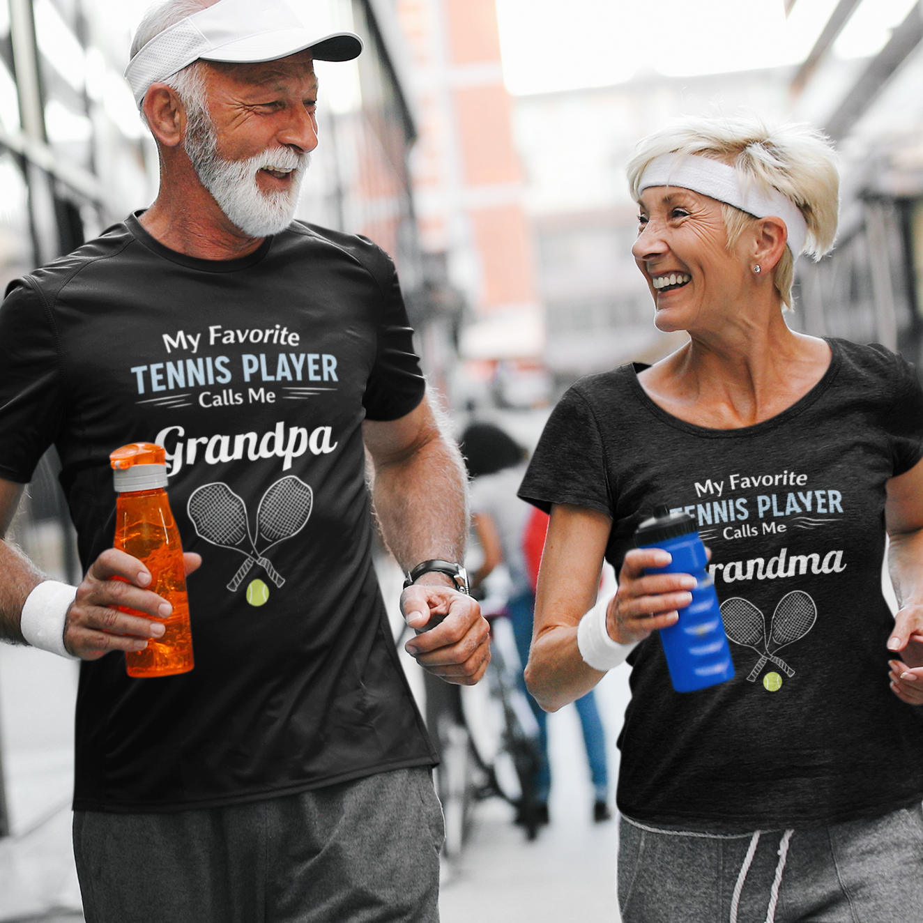 Two people wearing matching black t-shirts with tennis-themed text, walking together.