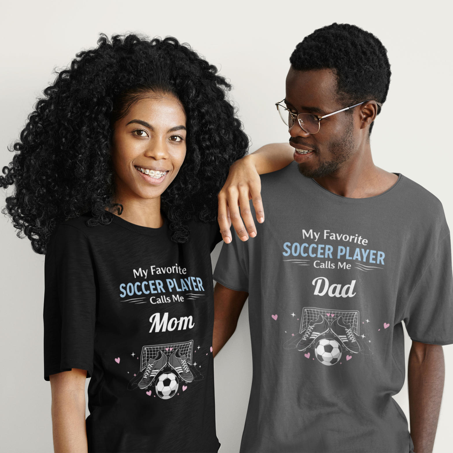 Two people wearing t-shirts with football-themed text and graphics.